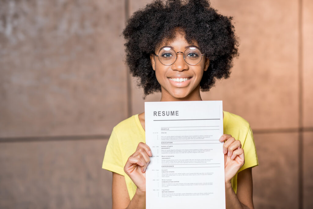 young african woman holding resume, graduating college with no job